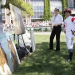  Jockey Victor Espinoza, right, looks over artwork by Susan Sommer-Luarca before riding in an undercard race at Belmont Park, Saturday, June 7, 2014, in Elmont, N.Y. Espinoza will ride favorite California Chrome in the Belmont Stakes later in the day. (AP Photo/Mark Lennihan)