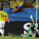 Colombia's James Rodriguez, left, scores his side's fourth goal during the group C World Cup soccer match between Japan and Colombia at the Arena Pantanal in Cuiaba, Brazil, Tuesday, June 24, 2014. (AP Photo/Kirsty Wigglesworth)