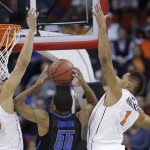 Memphis guard Geron Johnson (55) shoots against Virginia's Anthony Gill (13) and Justin Anderson (1) during the first half of an NCAA college basketball third-round tournament game, Sunday, March 23, 2014, in Raleigh. (AP Photo/Gerry Broome)