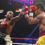 Floyd Mayweather Jr., left, trades punches with Manny Pacquiao, from the Philippines, during their welterweight title fight on Saturday, May 2, 2015 in Las Vegas. (AP Photo/John Locher)