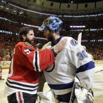 Chicago Blackhawks goalie Corey Crawford (50) talks to Tampa Bay Lightning goalie Ben Bishop (30) after Game 6 of the NHL hockey Stanley Cup Final series on Monday, June 15, 2015, in Chicago. The Blackhawks defeated the Lightning 2-0 to win the series 4-2. (AP Photo/Nam Y. Huh)

