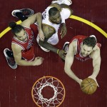 Chicago Bulls' Pau Gasol, right, drives to the basket against Cleveland Cavaliers' LeBron James, center, as Bulls' Joakim Noah, left, watches during the second half of Game 1 in a second-round NBA basketball playoff series Monday, May 4, 2015, in Cleveland. The Bulls defeated the Cavaliers 99-92. (AP Photo/Tony Dejak)