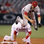 Arizona Diamondbacks shortstop Nick Ahmed, right, leaps after making the relay to first for a double play. after forcing out Los Angeles Angels' Mike Trout, left, at second, on a ball hit by Albert Pujols during the fourth inning of a baseball game in Anaheim, Calif., Monday, June 15, 2015. (AP Photo/Alex Gallardo)