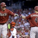 Arizona Diamondbacks' Mark Trumbo, left, is congratulated by teammate Cliff Pennington after hitting a solo home run during the fourth inning of a baseball game against the St. Louis Cardinals Wednesday, May 27, 2015, in St. Louis. (AP Photo/Jeff Roberson)
