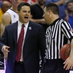 Arizona head coach Sean Miller, left, speaks with an official in the second half of an NCAA college basketball game in the quarterfinals of the Pac-12 conference tournament Thursday, March 12, 2015, in Las Vegas. Arizona won 73-51. (AP Photo/John Locher)