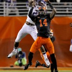 Oklahoma State linebacker Josh Furman (14) breaks up a pass intended for Washington wide receiver Kasen Williams during the first half of the Cactus Bowl NCAA college football game, Friday, Jan. 2, 2015, in Tempe, Ariz. (AP Photo/Rick Scuteri)