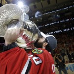 Chicago Blackhawks' goalie Corey Crawford kisses the Stanley Cup Trophy after defeating the Tampa Bay Lightning in Game 6 of the NHL hockey Stanley Cup Final series on Monday, June 15, 2015, in Chicago. The Blackhawks defeated the Lightning 2-0 to win the series 4-2. (AP Photo/Nam Y. Huh)
