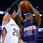 Phoenix Suns guard Eric Bledsoe (2) goes to the basket against New Orleans Pelicans guard Austin Rivers (25) during the first half of an NBA basketball game, Tuesday, Dec. 30, 2014, in New Orleans. (AP Photo/Jonathan Bachman)