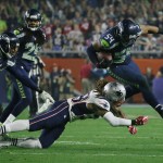 Seattle Seahawks middle linebacker Bobby Wagner (54) gets past New England Patriots running back Brandon Bolden (38) after intercepting a pass during the second half of NFL Super Bowl XLIX football game Sunday, Feb. 1, 2015, in Glendale, Ariz. (AP Photo/Matt York)