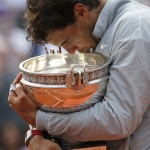 Spain's Rafael Nadal kisses the trophy after winning the final of the French Open tennis tournament against Serbia's Novak Djokovic at the Roland Garros stadium, in Paris, France, Sunday, June 8, 2014. Nadal won in four sets 3-6, 7-5, 6-2, 6-4. (AP Photo/Darko Vojinovic)