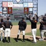 San Francisco Giants', from left, Angel Pagan, Brandon Belt (9), Hunter Pence and Madison Bumgarner watch the Kentucky Derby on the stadium video screen after a 5-4 win over the Los Angeles Angels in a baseball game on Saturday, May 2, 2015, in San Francisco. (AP Photo/Marcio Jose Sanchez)