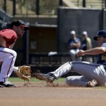 Milwaukee Brewers' Scooter Gennett, right, is tagged out at second by Arizona Diamondbacks second baseman Aaron Hill after trying to steal during the first inning of a spring exhibition baseball game in Scottsdale, Ariz., Sunday, March 16, 2014. (AP Photo/Chris Carlson)