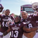 Mississippi State players including defensive lineman Ryan Brown (48), running back Josh Robinson (13) and defensive lineman Nick James (88) celebrate after their 48-31 win over No. 5 Texas A&M in an NCAA college football game in Starkville, Miss., Saturday, Oct. 4, 2014. (AP Photo/Jim Lytle)