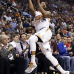 Phoenix Suns' Marcus Morris jumps to save the ball before it goes out of bounds during the second half of an NBA basketball game against the Miami Heat, Tuesday, Dec. 9, 2014, in Phoenix. The Heat won 103-97. (AP Photo/Ross D. Franklin)
