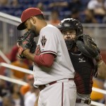 Arizona Diamondbacks relief pitcher Enrique Burgos, left, and catcher Tuffy Gosewisch talk on the mound during the ninth inning of a baseball game against the Miami Marlins in Miami, Tuesday, May 19, 2015. The Diamondbacks won 4-2. (AP Photo/J Pat Carter)