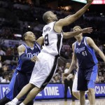 San Antonio Spurs' Tony Parker (9), of France, shoots around Dallas Mavericks' Shawn Marion, left, and Dirk Nowitzki (41), of Germany, during the first half of Game 2 of the opening-round NBA basketball playoff series on Wednesday, April 23, 2014, in San Antonio. (AP Photo/Eric Gay)