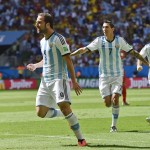 Argentina's Gonzalo Higuain, left, celebrates with Angel di Maria and Lionel Messi, right, after scoring the opening goal during the World Cup quarterfinal soccer match between Argentina and Belgium at the Estadio Nacional in Brasilia, Brazil, Saturday, July 5, 2014. (AP Photo/Martin Meissner)