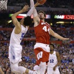 Wisconsin's Frank Kaminsky blocks a shot by Duke's Tyus Jones, left, during the first half of the NCAA Final Four college basketball tournament championship game Monday, April 6, 2015, in Indianapolis. (AP Photo/Michael Conroy)