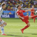Belgium's Dries Mertens, right, clears the ball as Argentina's Rodrigo Palacio closes in during the World Cup quarterfinal soccer match between Argentina and Belgium at the Estadio Nacional in Brasilia, Brazil, Saturday, July 5, 2014. (AP Photo/Frank Augstein)