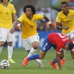 Brazil's Marcelo fights for the ball with Chile's Alexis Sanchez during the World Cup round of 16 soccer match between Brazil and Chile at the Mineirao Stadium in Belo Horizonte, Brazil, Saturday, June 28, 2014. (AP Photo/Frank Augstein)
