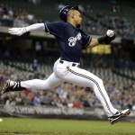 Milwaukee Brewers' Carlos Gomez loses his helmet as he races to first on a bunt during the sixth inning of a baseball game against the Arizona Diamondbacks Wednesday, May 7, 2014, in Milwaukee. Gomez beat the throw. (AP Photo/Morry Gash)