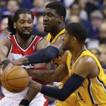  Washington Wizards forward Nene, left, passes around Indiana Pacers center Roy Hibbert (55) and forward Paul George (24) during the second half in Game 6 of an Eastern Conference semifinal NBA basketball playoff series in Washington, Thursday, May 15, 2014. (AP Photo/Alex Brandon)