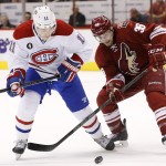 Arizona Coyotes' Mark Arcobello (36) and Montreal Canadiens' Brendan Gallagher (11) battle for the puck during the first period of an NHL hockey game Saturday, March 7, 2015, in Glendale, Ariz. (AP Photo/Ross D. Franklin)
