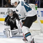 San Jose Sharks center Tomas Hertl, right, of the Czech Republic, tries to get a shot in on Los Angeles Kings goalie Jonathan Quick during the first period of an NHL hockey game, Wednesday, Oct. 8, 2014, in Los Angeles. (AP Photo/Mark J. Terrill)