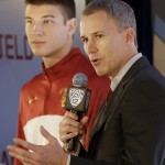 Southern California head coach Andy Enfield, right, speaks next to forward Nikola Jovanovic during NCAA college basketball Pac-12 media day in San Francisco, Thursday, Oct. 23, 2014. (AP Photo/Jeff Chiu)