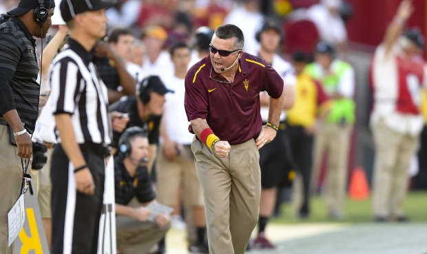 Arizona State head coach Todd Graham, center, reacts during the first half of an NCAA college footb...