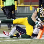 Green Bay Packers' Jordy Nelson scores a touchdown in front of New England Patriots' Devin McCourty after a catch during the first half of an NFL football game Sunday, Nov. 30, 2014, in Green Bay, Wis. (AP Photo/Mike Roemer)
