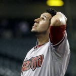 Arizona Diamondbacks' David Peralta looks up during a rain delay in a baseball game against the Cleveland Indians, Tuesday, Aug. 12, 2014, in Cleveland. (AP Photo/Tony Dejak)