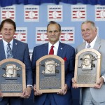 National Baseball Hall of Fame inductees, from left to right, Tony La Russa, Joe Torre and Bobby Cox hold their plaques after an induction ceremony at the Clark Sports Center on Sunday, July 27, 2014, in Cooperstown, N.Y. (AP Photo/Mike Groll)