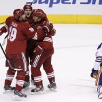  Phoenix Coyotes' Oliver Ekman-Larsson, second from left, of Sweden, celebrates his goal with teammates Shane Doan, left, and Antoine Vermette as Edmonton Oilers' Justin Schultz (19) kneels on the ice during the second period of an NHL hockey game, Friday, April 4, 2014, in Glendale, Ariz. (AP Photo/Ross D. Franklin)