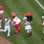 Cincinnati Reds' Billy Hamilton slaps hands with the mascots as introductions are made on the field before the start of their Opening day baseball game against the Pittsburgh Pirates played Monday, April 6, 2015 in Cincinnati. (AP Photo/Michael E. Keating)