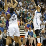 Phoenix Mercury center Brittney Griner, top left, lines up a shot against Minnesota Lynx forward Damiris Dantas (34) and guard Seimone Augustus, right, during the first half of Game 2 of the WNBA basketball Western Conference finals, Sunday, Aug. 31, 2014, in Minneapolis. (AP Photo/Stacy Bengs)