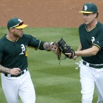 Actor Will Ferrell, right, congratulates Oakland Athletics' Brett Lawrie after the first inning of a spring training baseball game against the Seattle Mariners, Thursday, March 12, 2015, in Mesa, Ariz. The comedian plans to play every position while making appearances at five Arizona spring training games on Thursday. (AP Photo/Matt York)