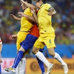  Chile's Marcelo Diaz is caught between Australia's Mark Milligan, left and Australia's Tim Cahill (4) during the second half of the group B World Cup soccer match between Chile and Australia in the Arena Pantanal in Cuiaba, Brazil, Friday, June 13, 2014. (AP Photo/Kirsty Wigglesworth)