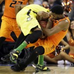 Oklahoma State guard Tavarius Shine, right, tries to steal the ball from Oregon forward Elgin Cook during the first half of an NCAA tournament college basketball game in the Round of 64, Friday, March 20, 2015, in Omaha, Neb. (AP Photo/Charlie Neibergall)