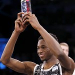 World Team's Andrew Wiggins, of the Minnesota Timberwolves, shows off his MVP trophy after NBA basketball's Rising Stars Challenge, Friday, Feb. 13, 2015, in New York. The World team defeated the U.S. team 121-112. (AP Photo/Julio Cortez)
