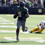 Leaving Wyoming safety Xavier Lewis (18) in his wake, Oregon running back Byron Marshall (9) runs for a touchdown during the second quarter of an NCAA college football game at Autzen Stadium, Saturday, Sept. 13, 2014, in Eugene, Ore. (AP Photo/Steve Dykes)