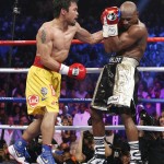 Manny Pacquiao, from the Philippines, left, connects with a left to the head of Floyd Mayweather Jr., during their welterweight title fight on Saturday, May 2, 2015 in Las Vegas. (AP Photo/John Locher)