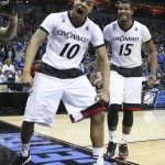 Cincinnati guard Troy Caupain, left, celebrates his game-tying basket against Purdue, forcing overtime, during an NCAA tournament second round college basketball game in Louisville, Ky., Thursday, March 19, 2015. At right is Cincinnati forward Jermaine Sanders. Cincinnati 66-65 in overtime. (AP Photo/David Stephenson)