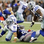 Dallas Cowboys' Tony Romo (9) is dragged down by New York Giants' Jason Pierre-Paul (90) in front of tackle Tyron Smith (77) during the first half of an NFL football game, Sunday, Oct. 19, 2014, in Arlington, Texas. (AP Photo/LM Otero)