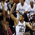 San Antonio Spurs forward Tim Duncan (21) shoots over Miami Heat center Chris Bosh (1) during the first half in Game 1 of the NBA basketball finals on Thursday, June 5, 2014, in San Antonio. (AP Photo/Tony Gutierrez)