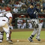  Milwaukee Brewers' Jonathan Lucroy, right, jumps out of the way of the ball and the catcher's mask thrown by Arizona Diamondbacks' Miguel Montero, left, during the ninth inning of a baseball game on Tuesday, June 17, 2014, in Phoenix. The Brewers defeated the Diamondbacks 7-5. (AP Photo/Ross D. Franklin)