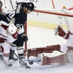Pittsburgh Penguins' Maxim Lapierre (40) can't get to a rebound as Arizona Coyotes goalie Mike Smith (41) falls into his net during the first period of an NHL hockey game in Pittsburgh, Saturday, March 28, 2015. (AP Photo/Gene J. Puskar)
