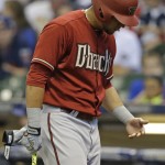 Arizona Diamondbacks' David Peralta looks at his hand as he leaves the game after being injured while batting against the Milwaukee Brewers during the first inning of a baseball game Sunday, May 31, 2015, in Milwaukee. (AP Photo/Jeffrey Phelps)