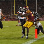 Southern California running back Justin Davis, second from right, scores as Oregon State safety Ryan Murphy, right, tries to drag him down as defensive end Dylan Wynn, left, and safety Brandon Arnold look on during the second half of an NCAA college football game, Saturday, Sept. 27, 2014, in Los Angeles. USC won the game 35-10. (AP Photo/Mark J. Terrill)