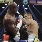 Marcos Maidana, right, from Argentina, lands a left against Floyd Mayweather Jr. in their WBC-WBA welterweight title boxing fight Saturday, May 3, 2014, in Las Vegas. (AP Photo/Isaac Brekken)